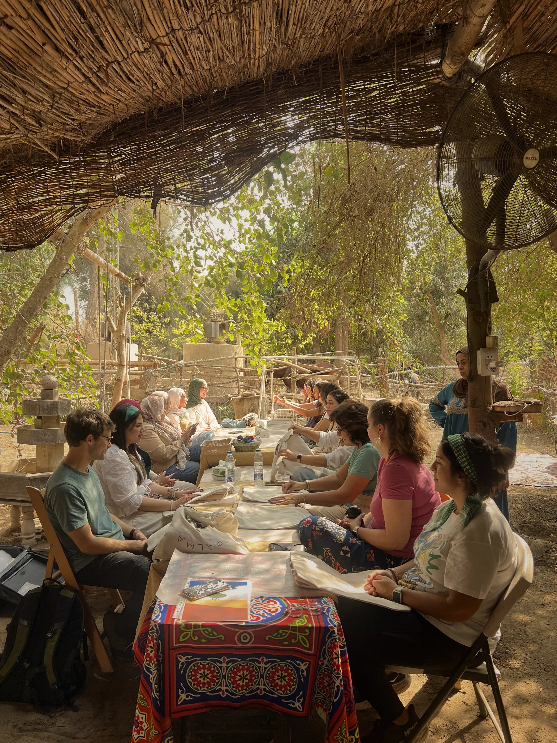 People gathered around a craft workshop table